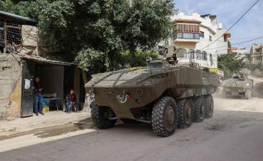 Israeli armoured vehicles drive by during a raid in the eastern neighbourhood of Jenin in the occupied West Bank