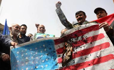 Iranians burn a US flag during a gathering in support of Gaza, in Tehran
