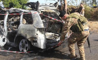 Lebanese security forces inspect the scene of the Israeli airstrike in Baawerta