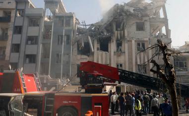 Rescuers work at the scene of a damaged building in the aftermath of Israeli strikes, in Tehran