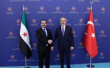 Turkish Foreign Minister Hakan Fidan shakes hands with his Syrian counterpart Asaad Hassan al-Shibani in Ankara