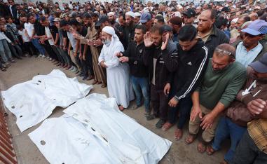 Mourners pray as they attend the funeral of Palestinians who were killed in overnight Israeli strikes in southern Gaza Strip