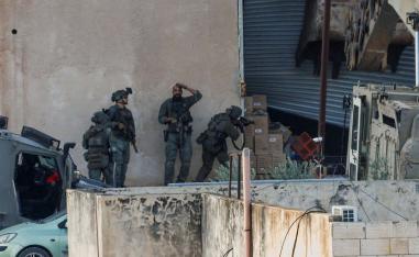 Israeli soldiers take position during a raid in Jenin in the Israeli-occupied West Bank