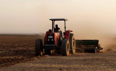 A farmer drives a tractor to plow land for wheat cultivation on the outskirts of Mosul, Iraq, November 26, 2025. 