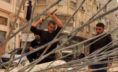 Palestinian workers break concrete to extract steel bars from destroyed homes amid a severe shortage of construction materials, in Khan Younis in the southern Gaza Strip, December 9, 2025. 