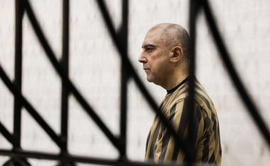 Atif Najib, a relative of Assad, appeared in court in handcuffs