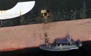 Iran's navy soldiers attacking a ship in the Strait of Hormuz