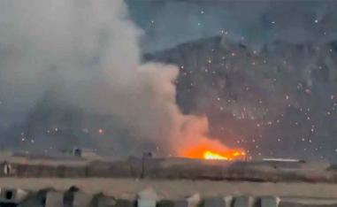 Burning debris litters the surrounding area, amid the US-Israeli conflict with Iran, in Baharestan, Isfahan province, Iran 