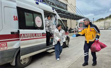 People rescued after a migrant boat sank off Turkey’s Aegean coast get out of an ambulance upon arrival at a hospital in Bodrum