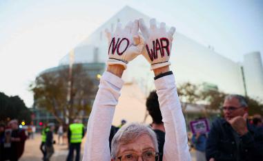 A demonstrator holds up her hands during an anti-war protest, calling for an end to the US-Israel conflict with Iran, in Tel Aviv,