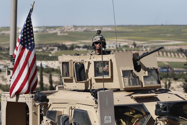US soldier sits in an armored vehicle