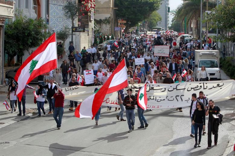 Protesters hold banners and Lebanese flags in Beirut