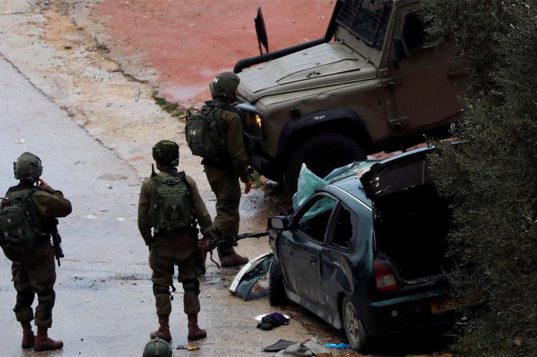 Israeli forces stand at the scene of the incident near Ramallah