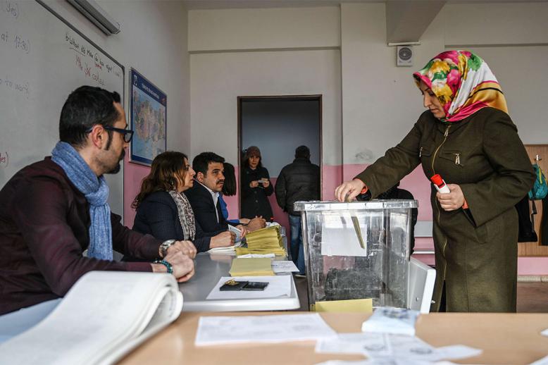 A woman casts her vote at a polling station in Istanbul 