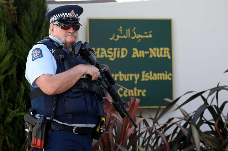 An armed police officer stands guard outside the Al Noor mosque in Christchurch 