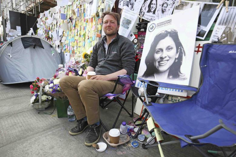 Richard Ratcliffe, the husband of detained Nazanin Zaghari Ratcliffe, with flower tributes and messages outside the Iranian Embassy in London