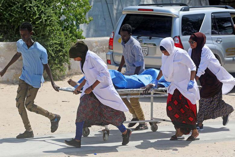 Nurses at the Medina hospital assist a civilian wounded in an explosion outside a hotel near the international airport in Mogadishu