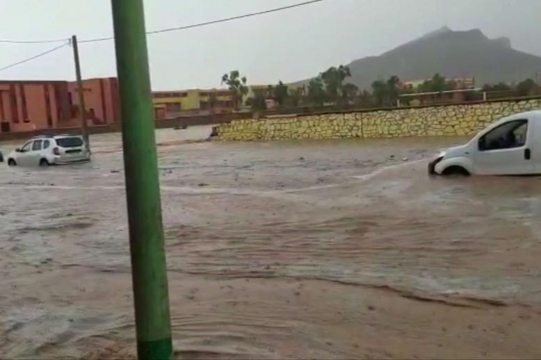 Photographs and videos shared on social media showed muddy waters carrying away people
