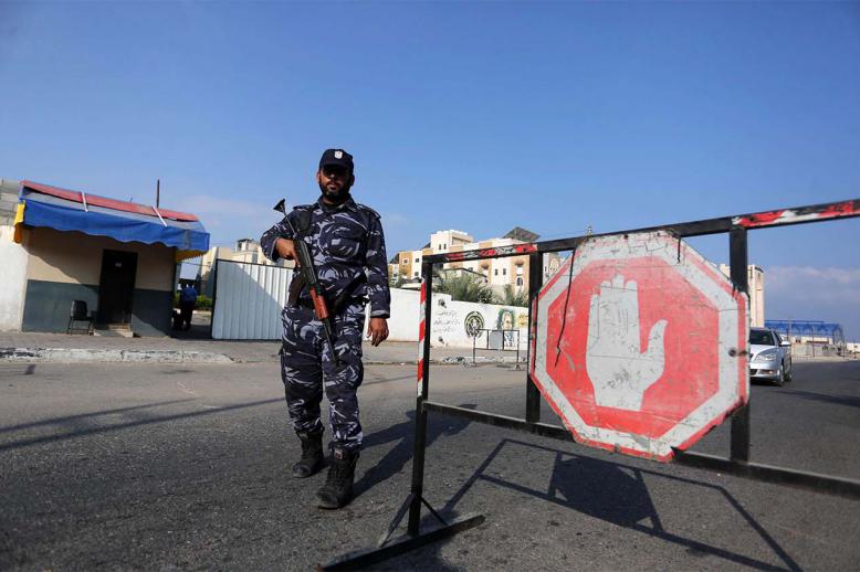 A Palestinian policeman stands guard at a checkpoint in Khan Younes