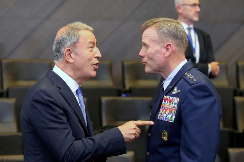 Turkish Defence Minister Hulusi Akar (L) speaks with the Supreme Allied Commander Europe, US Air Force General Tod Wolters,
