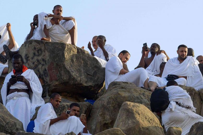 At the peak of Mount Arafat, numerous Muslim pilgrims were absorbed in Koranic verses displayed on their smartphones