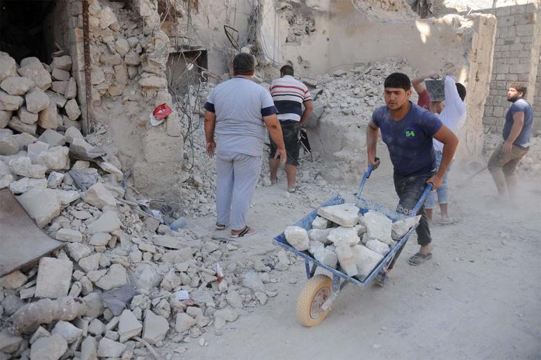 Workers taking part in restorations of the old Aleppo market 