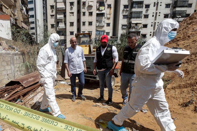 Forensic investigators of Lebanon's military intelligence inspecting the scene where two drones came down in the vicinity of a Hezbollah media centre last month
