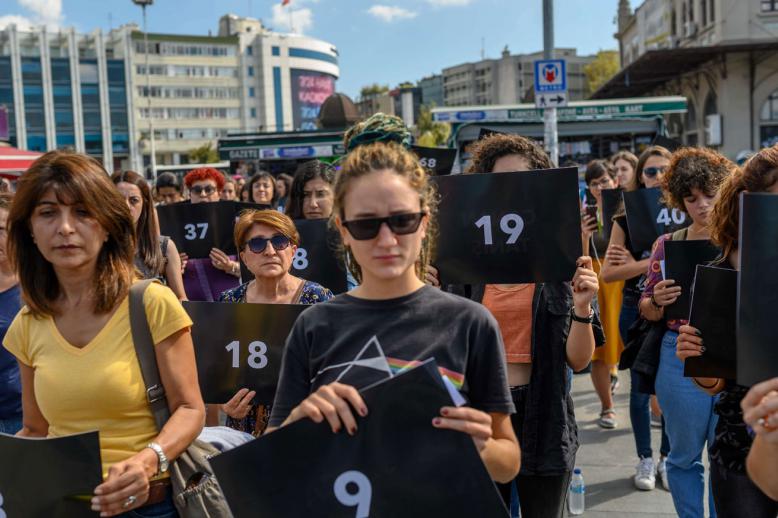 hold signs with different numbers symbolizing the women murders during a protest against gender violence in Istanbul