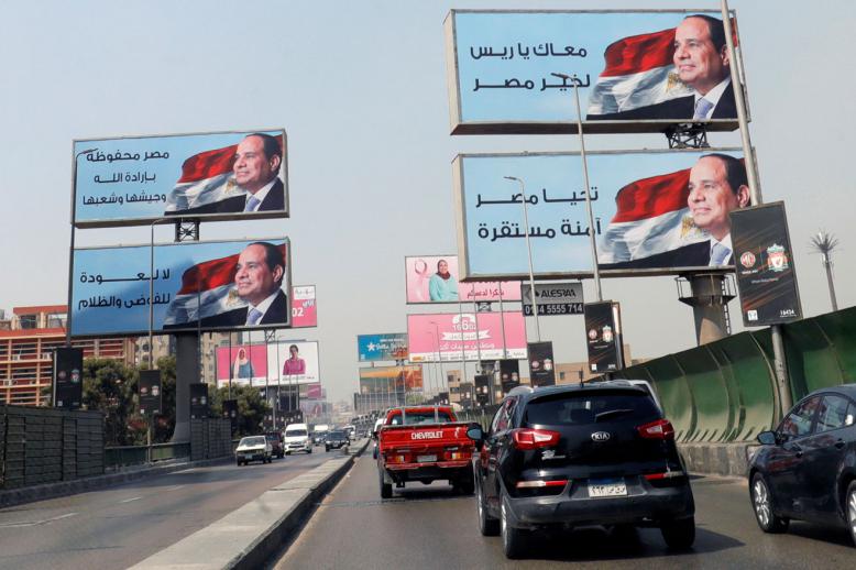 Cars move along the '6th October Bridge' near banners of Egyptian President Abdel Fattah al-Sisi