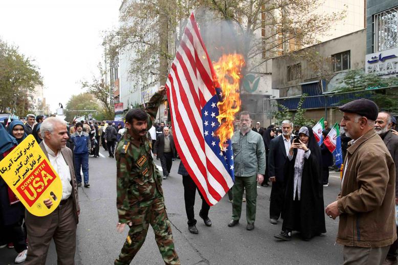 Iranians massed in front of the building carrying placards with slogans such as "Down with USA" and "Death to America."
