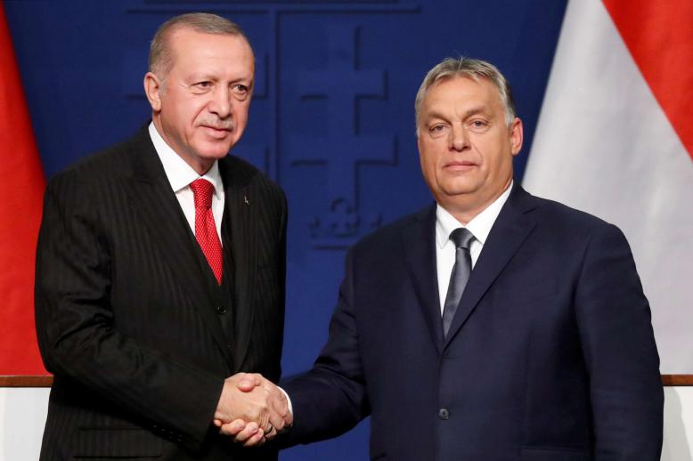 Turkish President Recep Tayyip Erdogan and Hungarian Prime Minister Viktor Orban shake hands during a news conference in Budapest