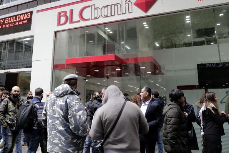 Lebanese protesters occupy a branch of BLC Bank in the capital Beirut