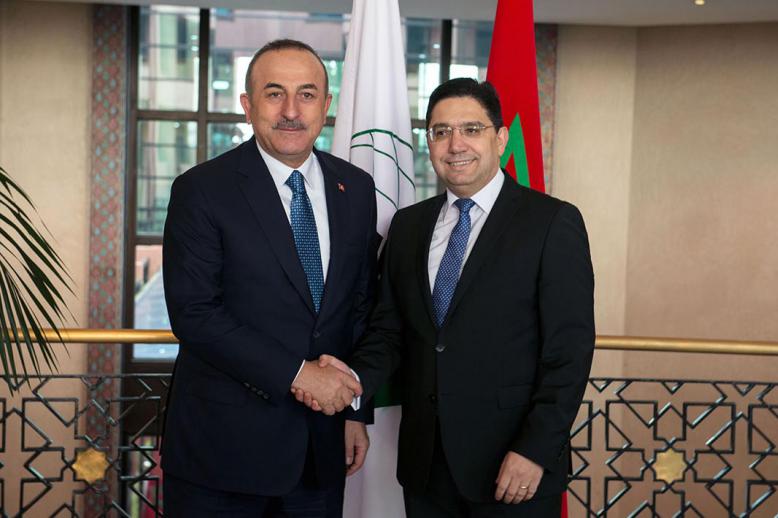 Turkish foreign minister Mevlut Cavusoglu shaking hands with Moroccan counterpart Nasser Bourita