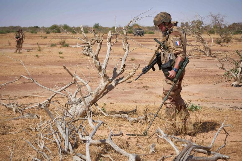 A French soldier holds a detector while searching for the presence of IEDs in northern Burkina Faso