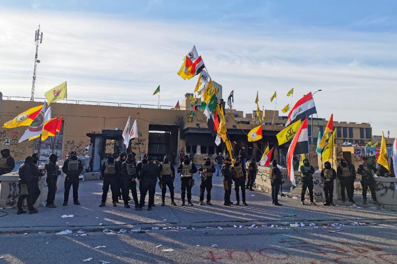 Protesters and militia fighters gather outside the US embassy in Baghdad