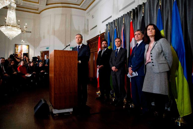 Canadian Minister of Foreign Affairs Francois-Philippe Champagne (C) addresses a press conference