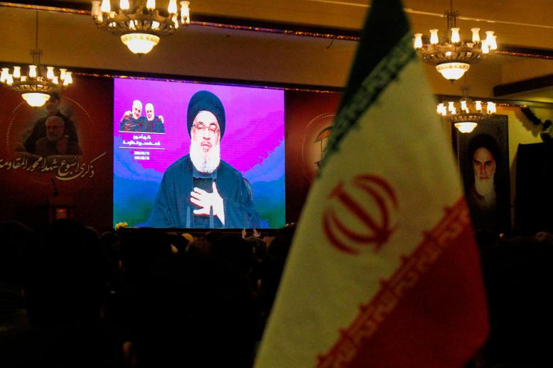 Supporters of the Shiite Hezbollah movement watch as leader Hasan Nasrallah delivers a speech