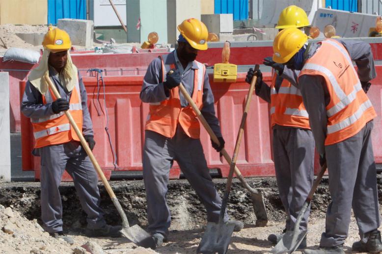 Workers are seen at a construction site in Doha