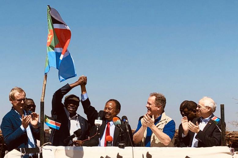 Sudanese PM Abdallah Hamdok clasps hands with rebel leader Abdelaziz al-Hilu in Kauda