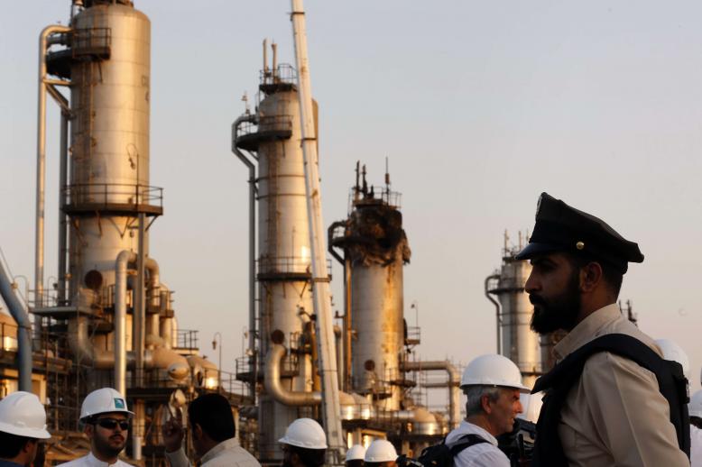 A security guard stands alert in front of Aramco's oil processing facility