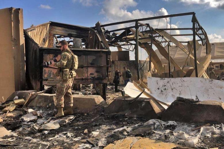 US soldiers and journalists inspect the rubble at a site of Iranian bombing, in Ain al-Asad air base, Anbar