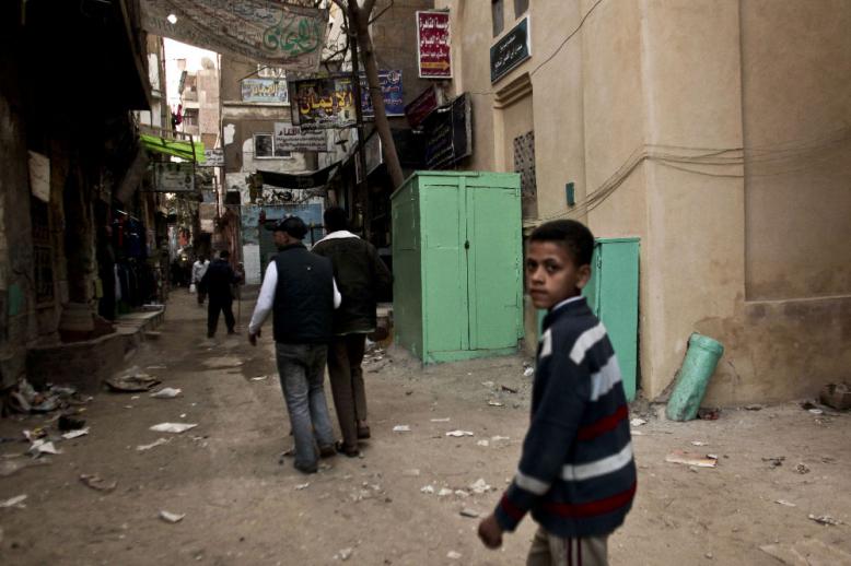 2012 photo shows a kiosk, center, used as a clinic where girls are circumcised by a barber in Giza, Egypt