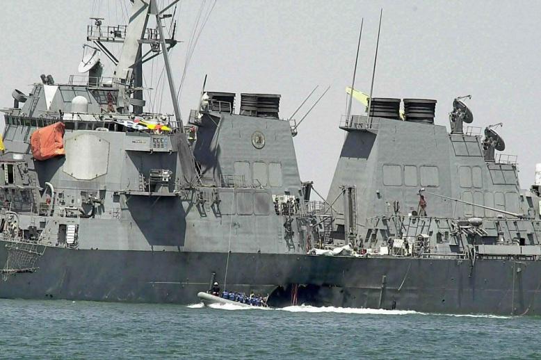 Oct. 15, 2000 file photo shows experts in a speed boat examining the damaged hull of the USS Cole at the Yemeni port of Aden
