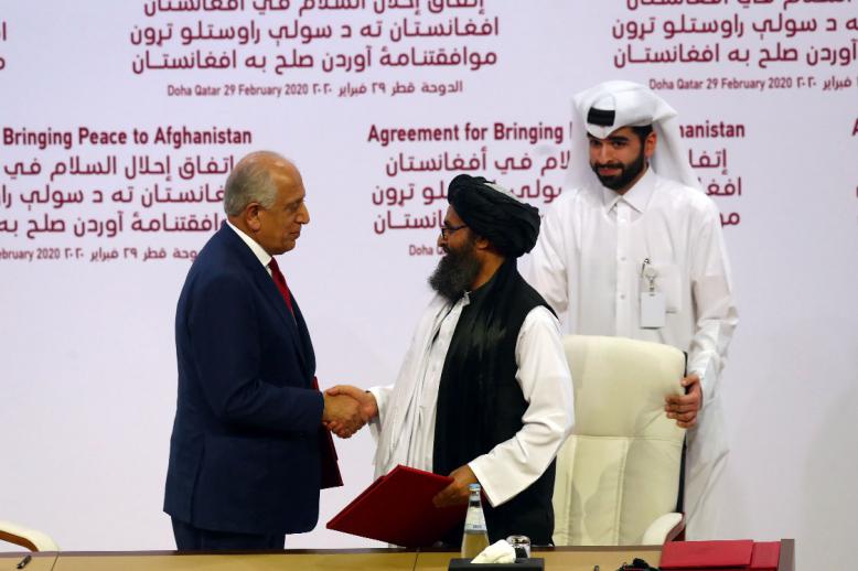 Zalmay Khalilzad, US envoy for peace in Afghanistan and Mullah Abdul Ghani Baradar, the leader of the Taliban delegation