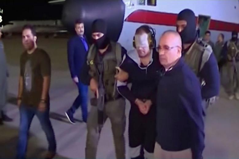 May 29, 2019 photo shows a blindfolded Hisham al-Ashmawy escorted by Egyptian military officers