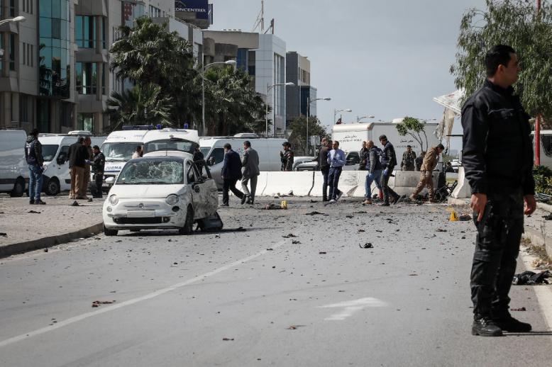 An armed Tunisian police officer at the site of an explosion near the US embassy