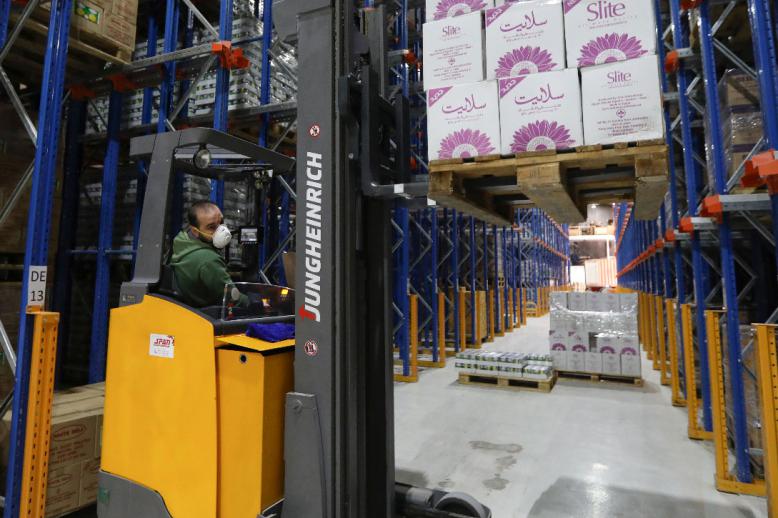 A worker wears a protective face mask as he works at Bohsali food warehouse