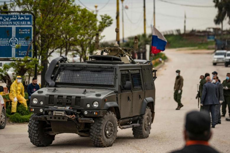 A Russian military vehicle drives in the vicinity of Qamishli airport, Syria