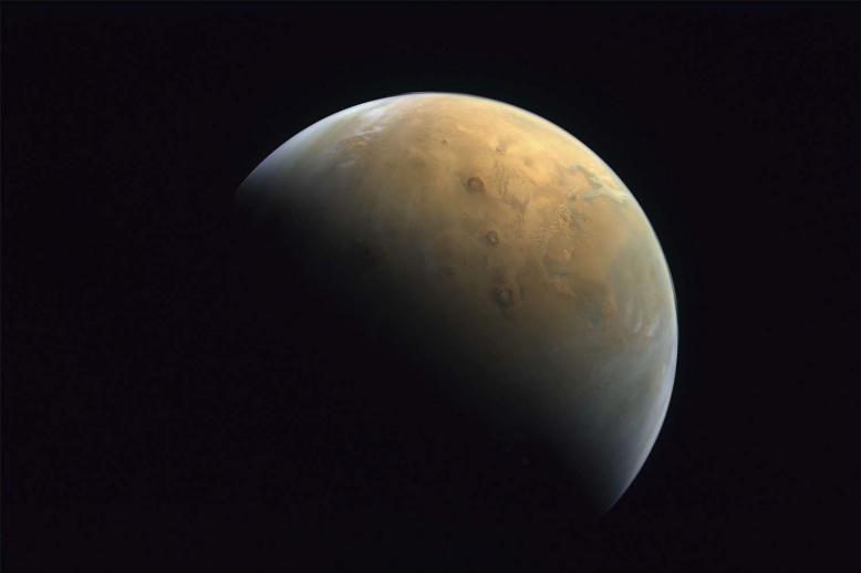 The image shows Mars' north pole, as well as Mars' largest volcano, Olympus Mons