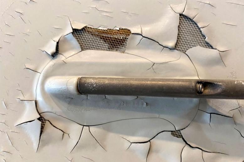 Paint peeling, cracking and exposed expanded copper foil on the fuselage of a Qatar Airways Airbus A350 aircraft